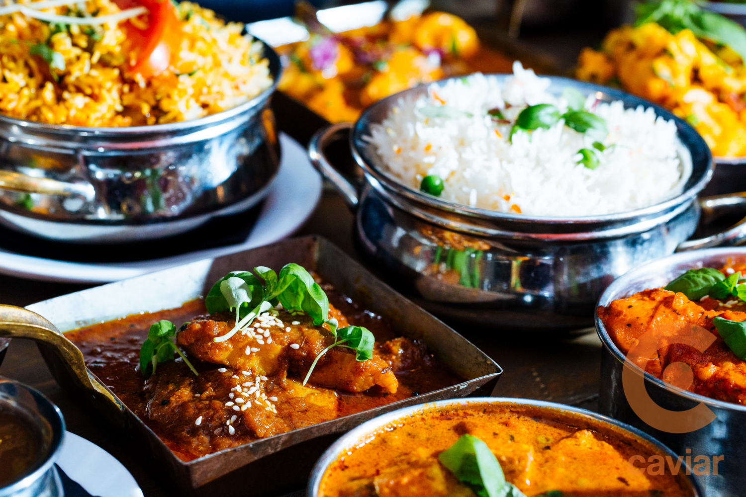 Indian feast with curries, rice, and biryani